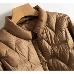 Women’s Aurora short quilted puffer jacket by Christine Brewer, featuring a stylish, insulated design with a high collar and quilted pattern.