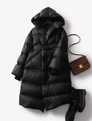 Christine Brewer Ella long belted puffer jacket for women, showcasing a stylish, insulated winter coat with a belt and quilted design.
