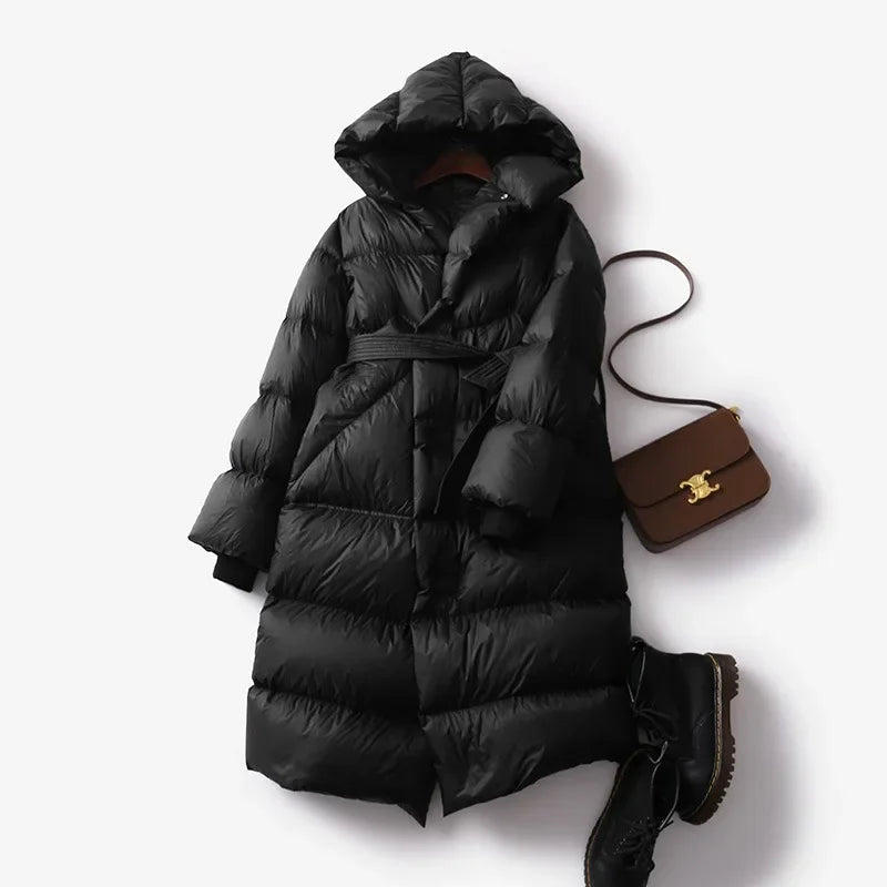 Christine Brewer Ella long belted puffer jacket for women, showcasing a stylish, insulated winter coat with a belt and quilted design.