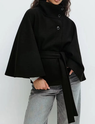 Emma belted cape coat for women by Christine Brewer, shown in a stylish, draped fabric with a belt at the waist.