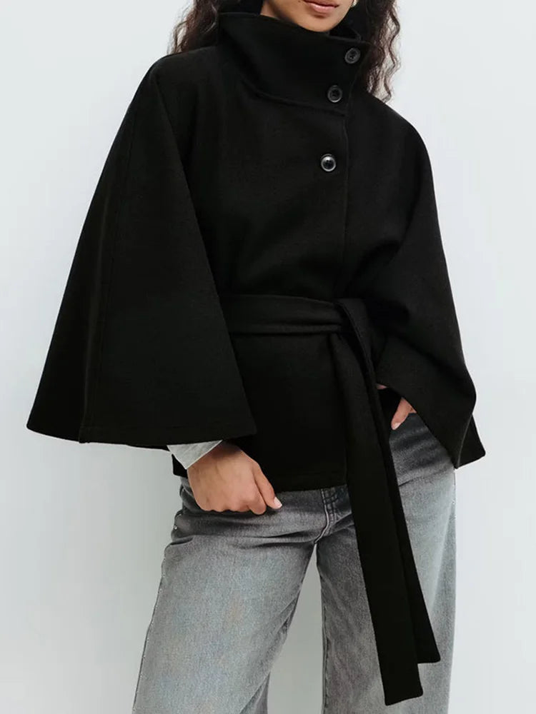 Emma belted cape coat for women by Christine Brewer, shown in a stylish, draped fabric with a belt at the waist.
