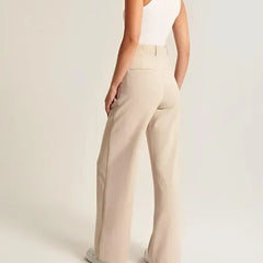 White wide-leg high-waist women's trousers by Christine Brewer, featuring a relaxed fit and elegant high-rise design.