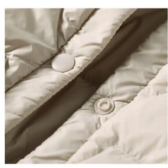 Women’s hooded quilted puffer jacket by Christine Brewer, featuring a stylish quilted design and cozy hood for cold weather.