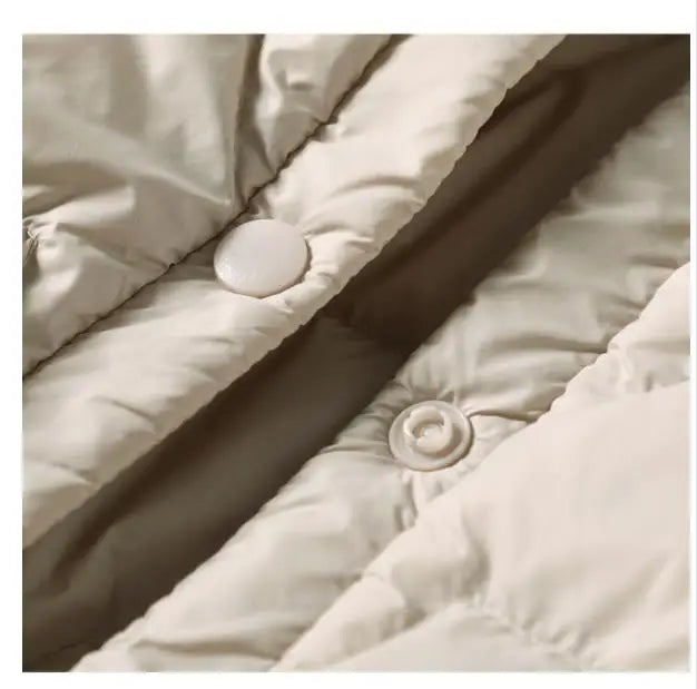 Women’s hooded quilted puffer jacket by Christine Brewer, featuring a stylish quilted design and cozy hood for cold weather.