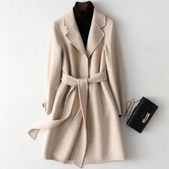 Olivia long belted wool coat for women by Christine Brewer, shown in a stylish dark gray with a belt and tailored fit.