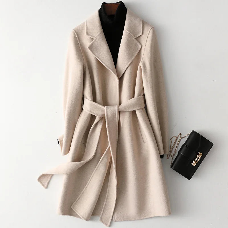 Olivia long belted wool coat for women by Christine Brewer, shown in a stylish dark gray with a belt and tailored fit.