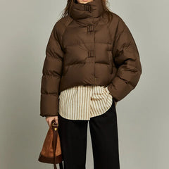 Women’s cropped quilted parka by Christine Brewer, featuring a stylish, insulated design with a high collar and cozy fit.