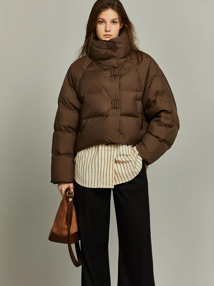Women’s cropped quilted parka by Christine Brewer, featuring a stylish, insulated design with a high collar and cozy fit.