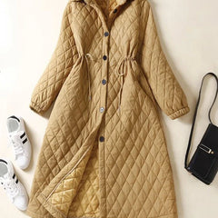 Longline Elena puffer jacket for women by Christine Brewer, featuring a warm, quilted design with a hood and stylish silhouette.