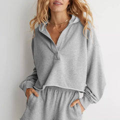 Pink cropped hoodie for women by Christine Brewer, featuring a relaxed fit and casual style.