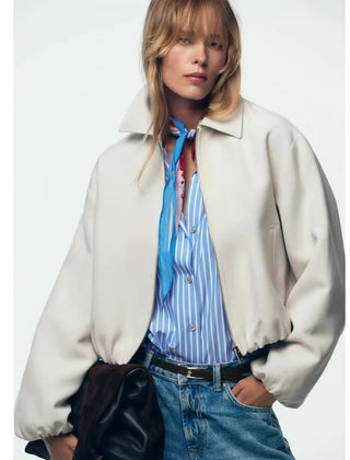Violet zip-up puffer jacket for women by Christine Brewer, featuring a quilted design and stand-up collar.