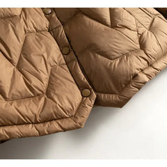 Women’s Aurora short quilted puffer jacket by Christine Brewer, featuring a stylish quilted design and cozy insulated construction.