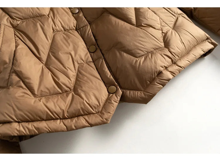 Women’s Aurora short quilted puffer jacket by Christine Brewer, featuring a stylish quilted design and cozy insulated construction.