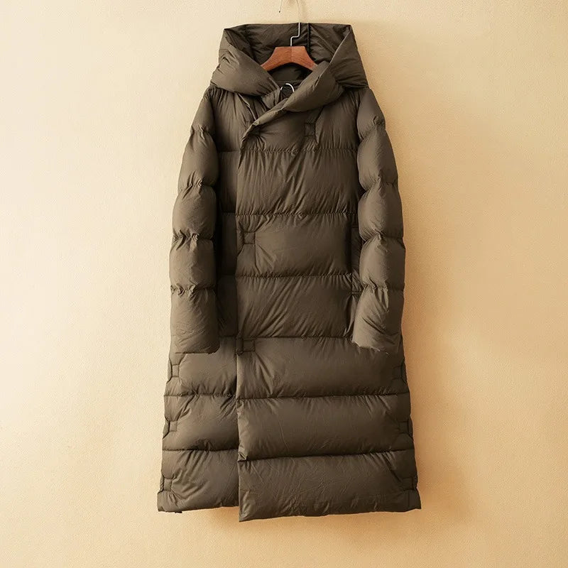 Long hooded parka for women by Christine Brewer, featuring a stylish design and cozy hood for warmth and comfort.