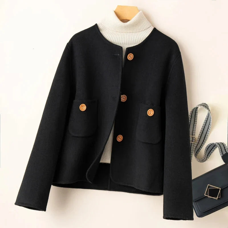 Elegant wool coat for women from Christine Brewer, featuring a tailored fit and classic design in a neutral color.
