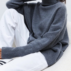 Cream-colored Erica oversized women's turtleneck sweater by Christine Brewer, featuring a cozy, relaxed fit and ribbed collar.