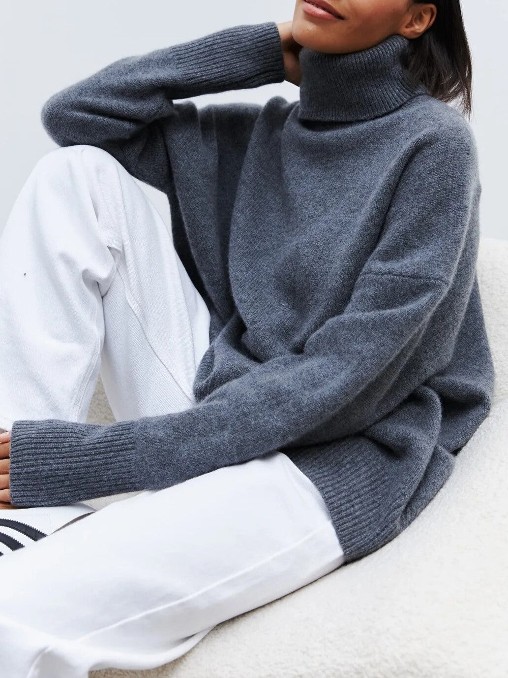 Cream-colored Erica oversized women's turtleneck sweater by Christine Brewer, featuring a cozy, relaxed fit and ribbed collar.