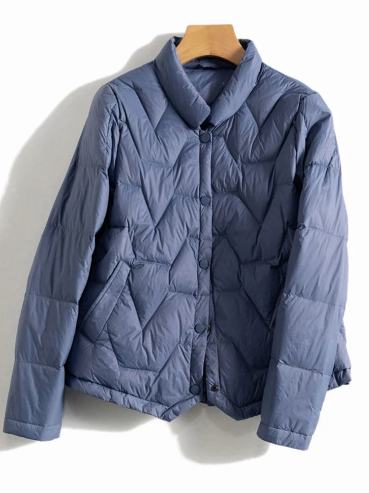 Pink quilted puffer jacket for women by Christine Brewer, featuring a short, stylish design with a quilted pattern.