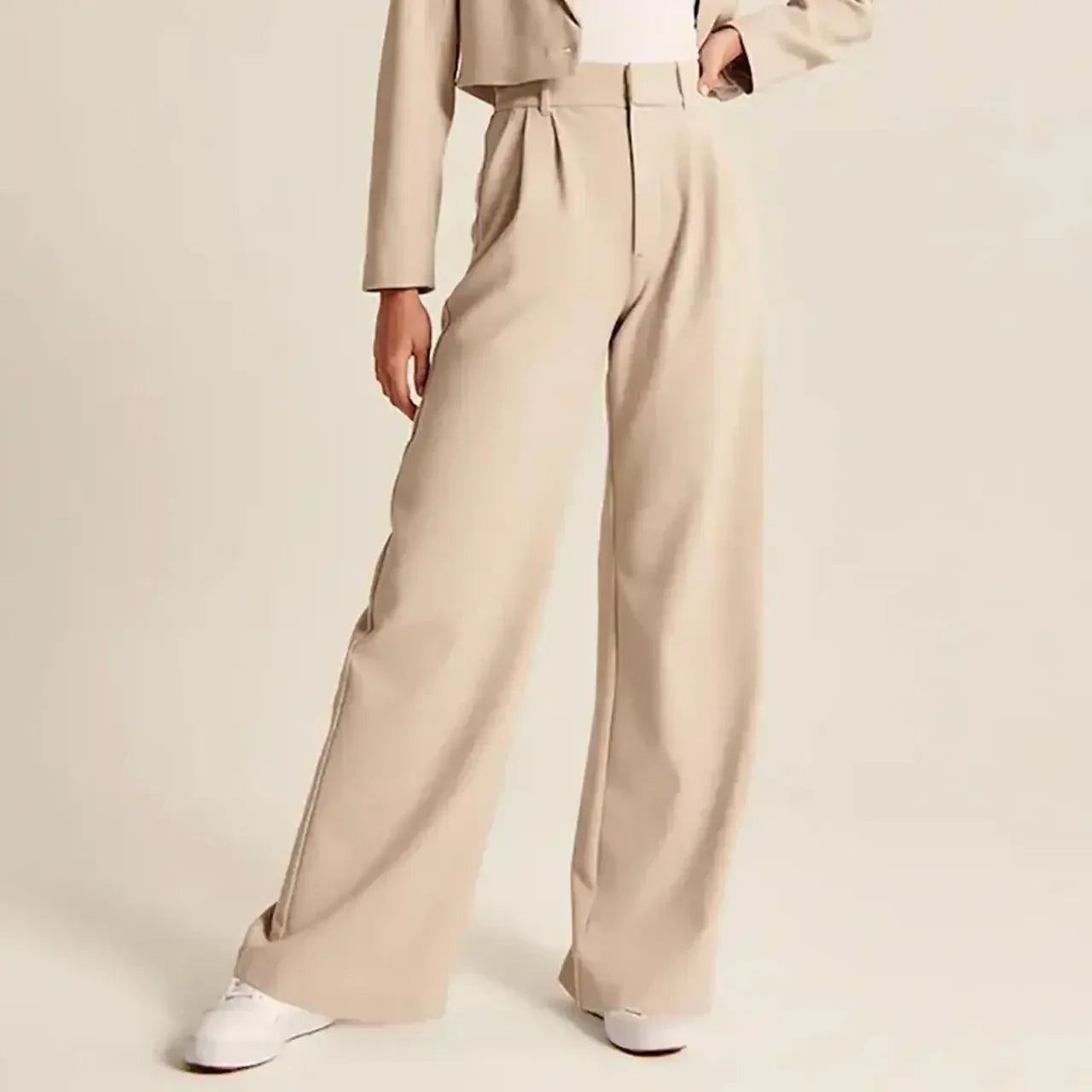 White wide-leg high-waist pants for women by Christine Brewer, shown on a model, featuring a relaxed fit and elegant style.