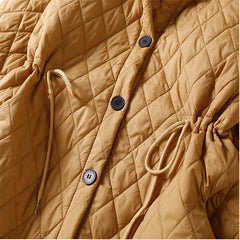 Longline red puffer jacket for women, the Elena by Christine Brewer, featuring a cozy design and sleek longline silhouette.