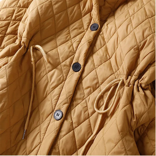 Longline red puffer jacket for women, the Elena by Christine Brewer, featuring a cozy design and sleek longline silhouette.