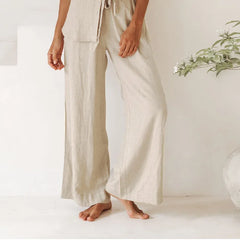 Light beige linen wide-leg trousers for women by Christine Brewer, featuring a loose pull-on style and relaxed fit.