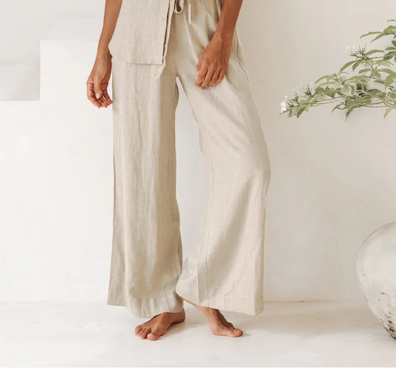 Light beige linen wide-leg trousers for women by Christine Brewer, featuring a loose pull-on style and relaxed fit.