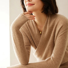 Cream-colored Dawn cashmere sweater for women by Christine Brewer, shown on a hanger with soft knit details.
