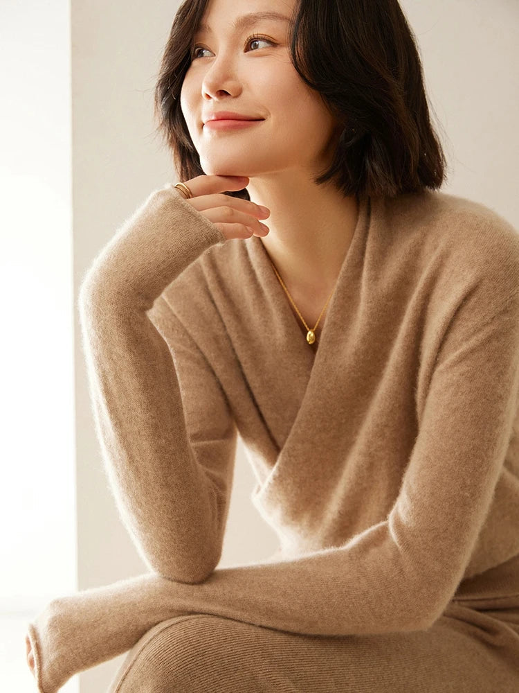 Cream-colored Dawn cashmere sweater for women by Christine Brewer, shown on a hanger with soft knit details.