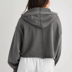 Christine Brewer Eleanor women's cropped hoodie displayed on a model, featuring a casual, stylish fit with a drawstring hood.