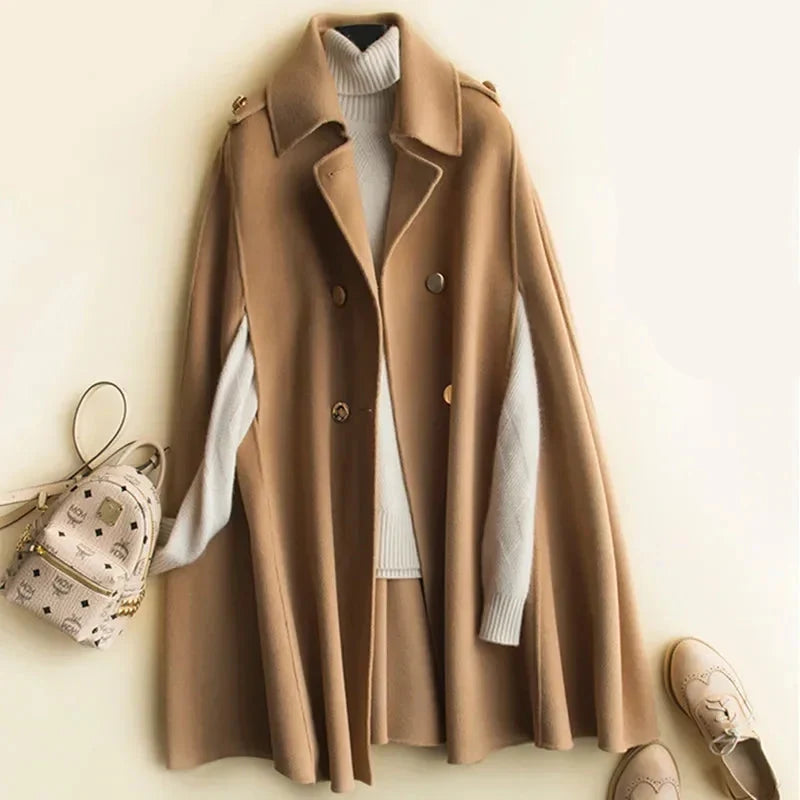 Elegant ivory cape coat for women by Christine Brewer, featuring a flowing design and stylish collar detail.