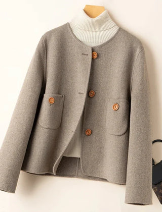 Elegant wool coat for women by Christine Brewer, featuring a tailored fit and classic design in a neutral color.