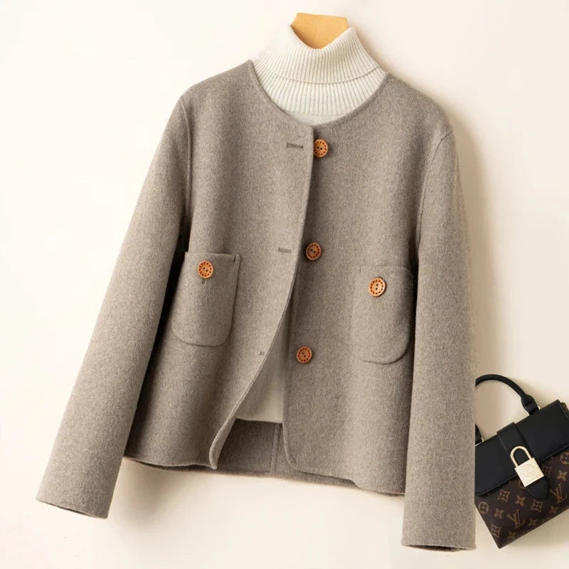 Elegant wool coat for women by Christine Brewer, featuring a tailored fit and classic design in a neutral color.