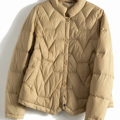 Women’s quilted puffer jacket by Christine Brewer, Aurora style, featuring short length, quilted design, and warm, lightweight insulation.