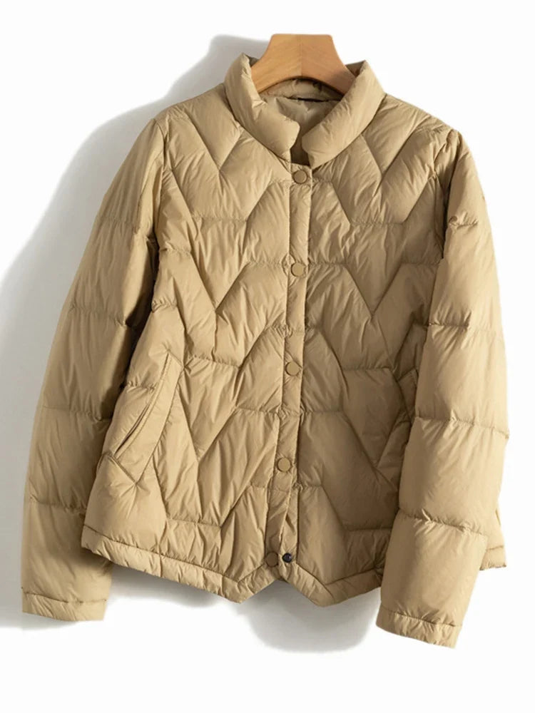 Women’s quilted puffer jacket by Christine Brewer, Aurora style, featuring short length, quilted design, and warm, lightweight insulation.