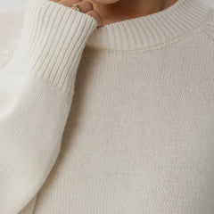 Oversized women's wool sweater from Flora by Christine Brewer, featuring a cozy, chunky knit in neutral tones.