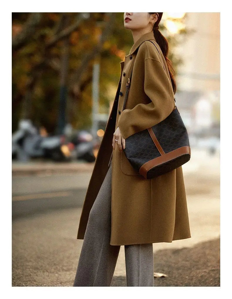 Green long wool coat for women by Christine Brewer, featuring a stylish and cozy design with a tailored fit.