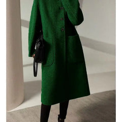 Green wool long coat for women by Christine Brewer, shown on a model, featuring a classic tailored design and soft fabric.