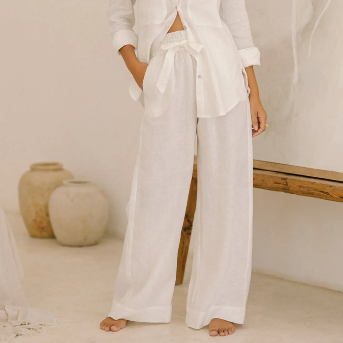 Women’s linen wide-leg trousers by Christine Brewer, loose pull-on pants with relaxed fit and natural fabric texture.
