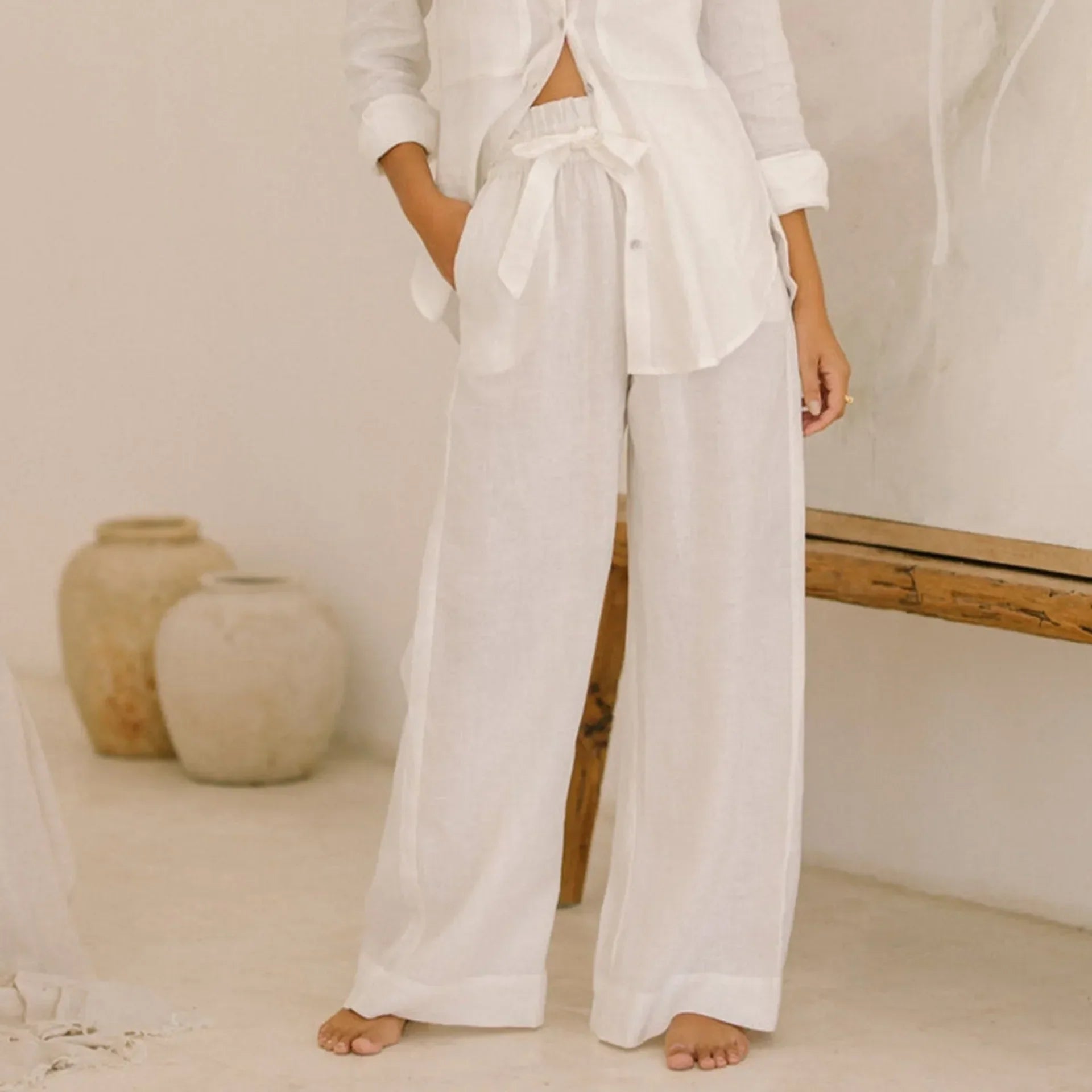 Women’s linen wide-leg trousers by Christine Brewer, loose pull-on pants with relaxed fit and natural fabric texture.