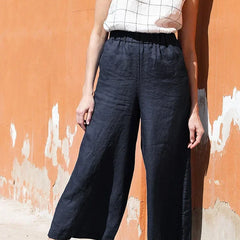 Women’s linen cropped wide-leg trousers with drawstring waist, loose pull-on style by Christine Brewer, shown in a relaxed fit with natural fabric.