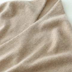 Helen cashmere sweater for women by Christine Brewer, soft beige knit with a relaxed fit, displayed on a hanger.