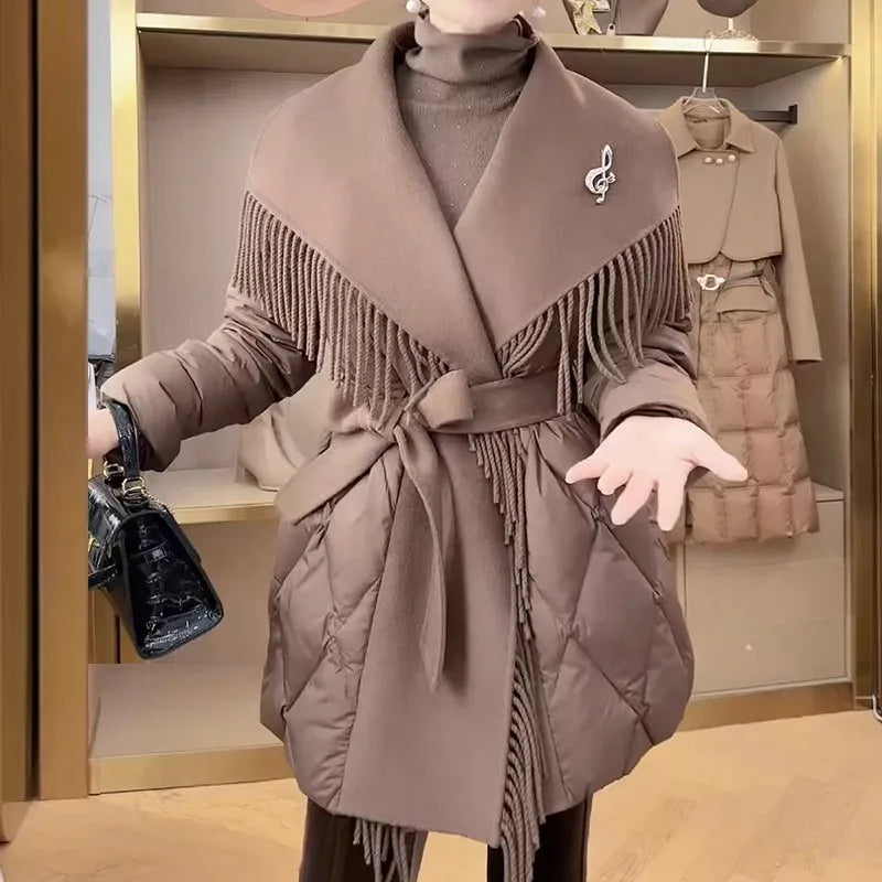 Women’s belted quilted puffer jacket by Christine Brewer, Stella collection, with a hood and padded design for warmth and style.