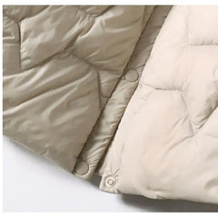 Women’s quilted puffer jacket with hood by Christine Brewer, featuring a stylish quilted design and cozy insulation.