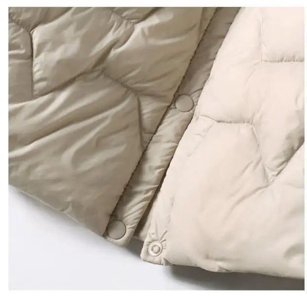 Women’s quilted puffer jacket with hood by Christine Brewer, featuring a stylish quilted design and cozy insulation.
