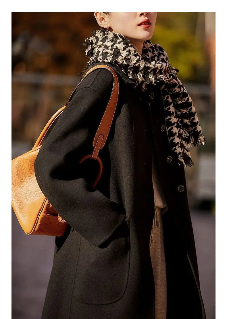 Green long wool coat for women by Christine Brewer, featuring a stylish, tailored design perfect for cold weather.