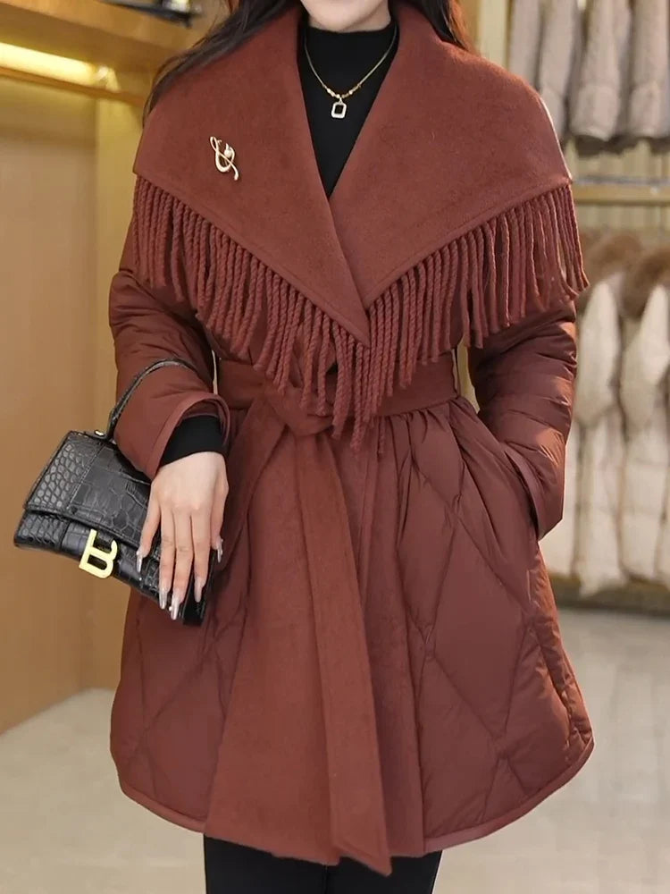 Women’s belted quilted puffer jacket by Christine Brewer featuring a stylish quilted design and a waist belt for a chic look.