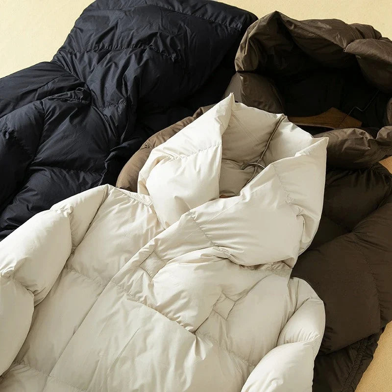 Long hooded parka for women by Christine Brewer, featuring a cozy design, adjustable hood, and stylish outerwear for cold weather.