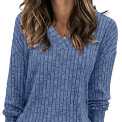 Oversized V-neck sweater for women by Christine Brewer, featuring a cozy fit and soft knit fabric in a neutral color.