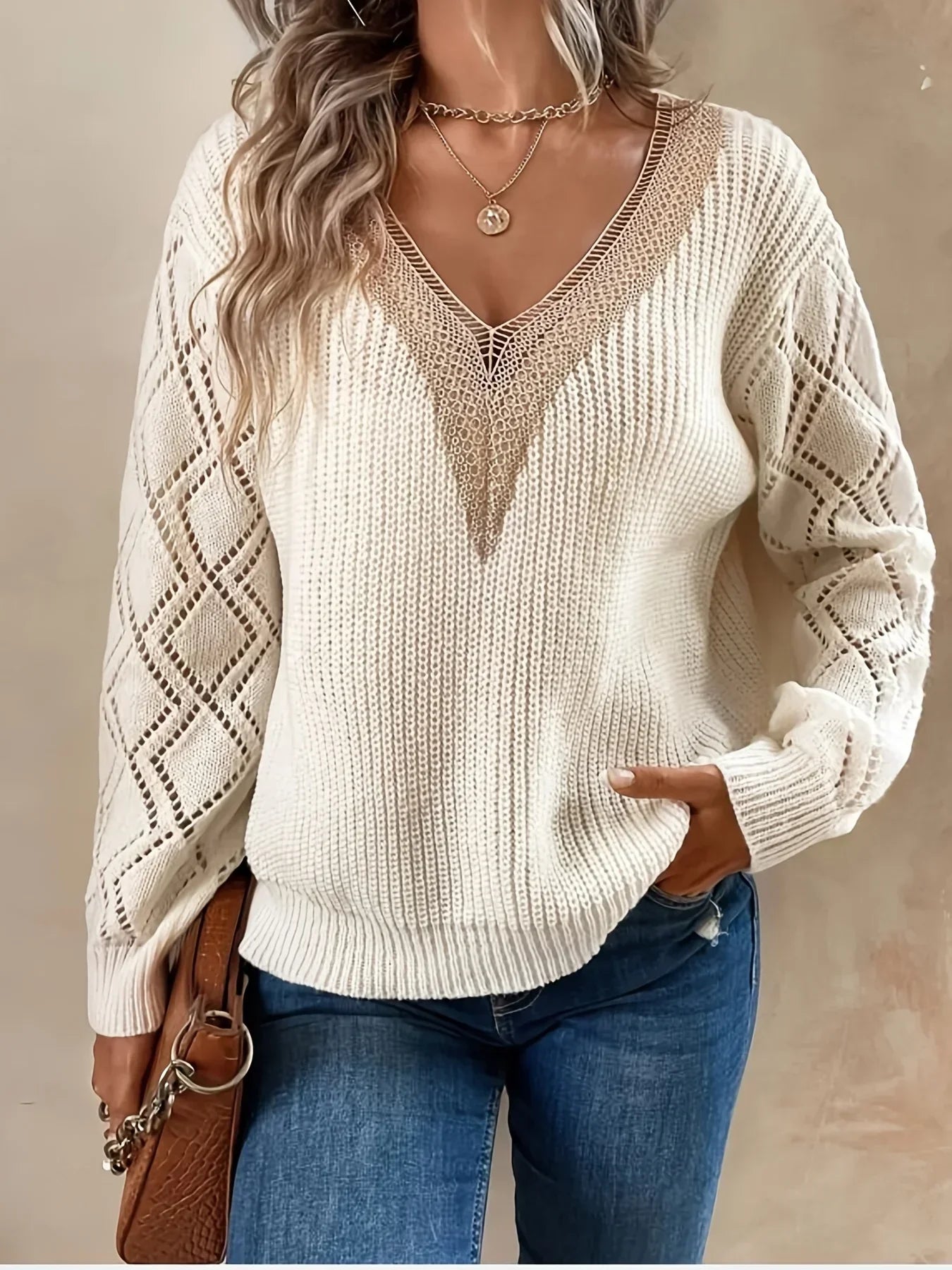Beige V-neck sweater for women by Christine Brewer, featuring a cozy knit design and long sleeves.